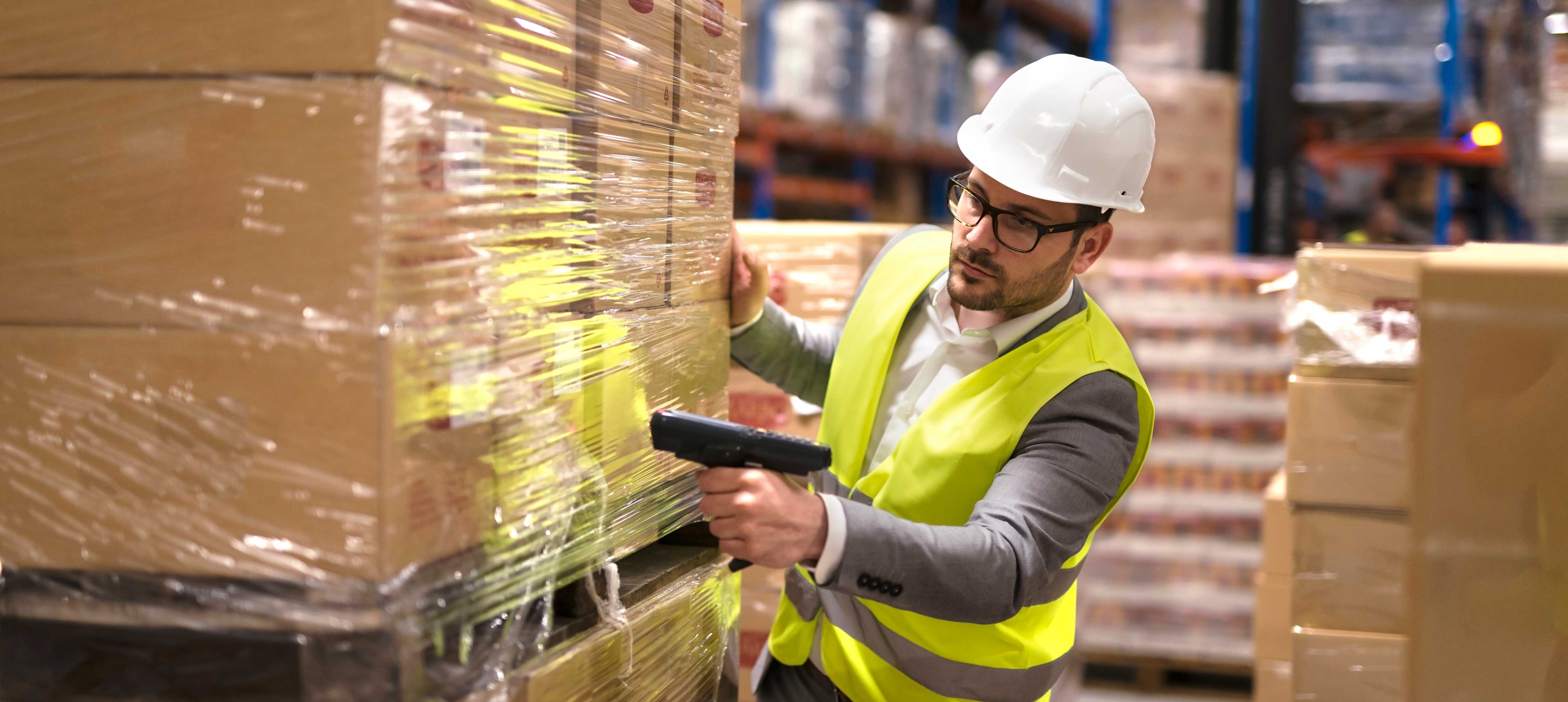 male-warehouse-worker-using-bar-code-scanner-analyze-newly-arrived-goods-further-placement-storage-department