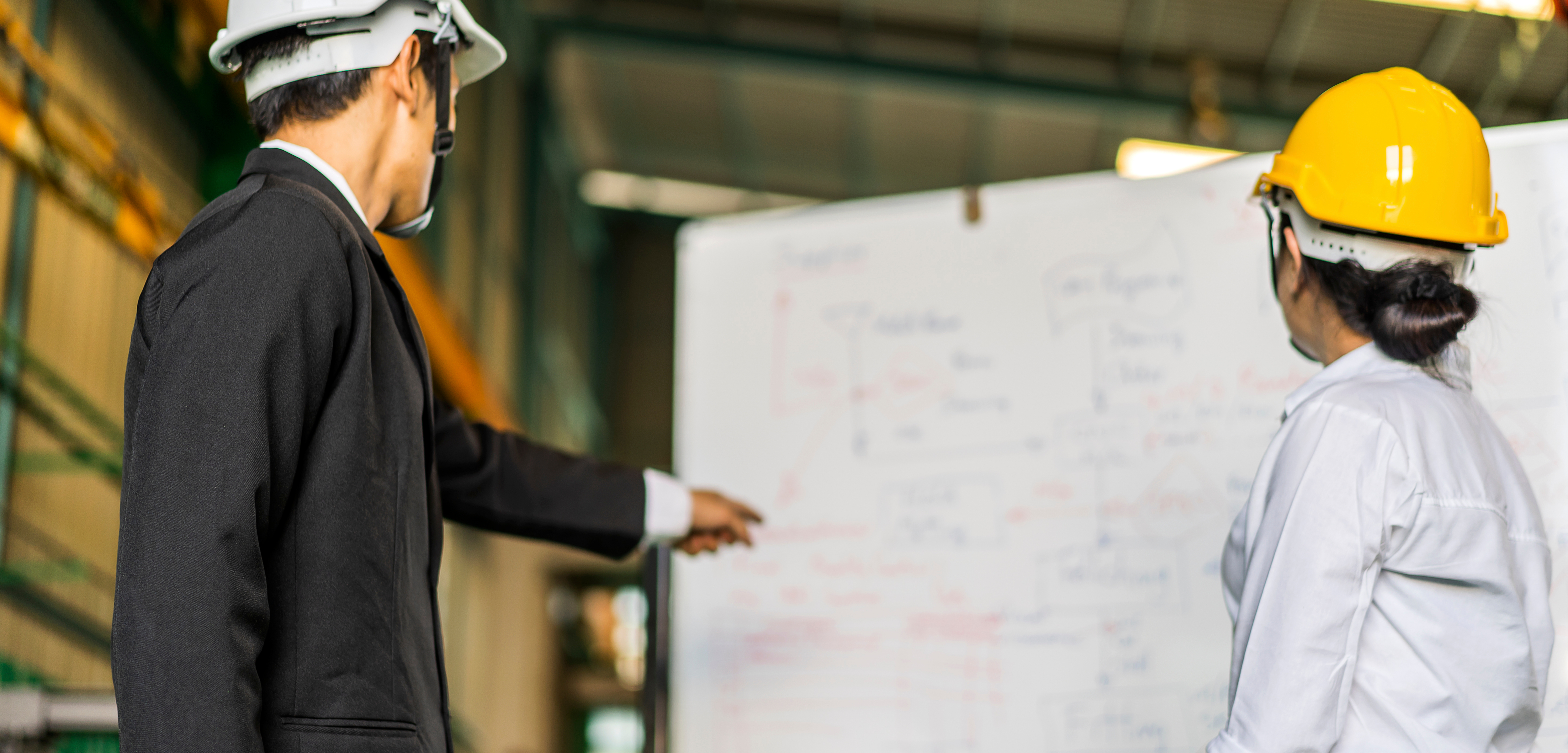 Team of engineers having a whiteboard discussion