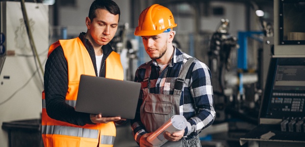 Two men reviewing data at manufacturing site